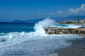Waves break about a stone pier