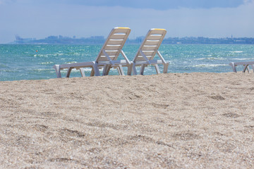chaise lounge on the sandy beach and a view of the horizon
