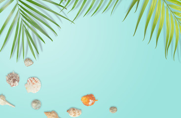 Fototapeta na wymiar Seashells with tropical leaves frame on blue background. Summer beach concept