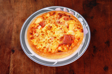 Pizza on the brown wood table      