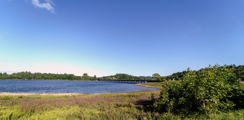 Panoramic view of a lake and its shores formed by the Cecebre reservoir in Galicia (Spain). On the right the bridge that crosses it looks