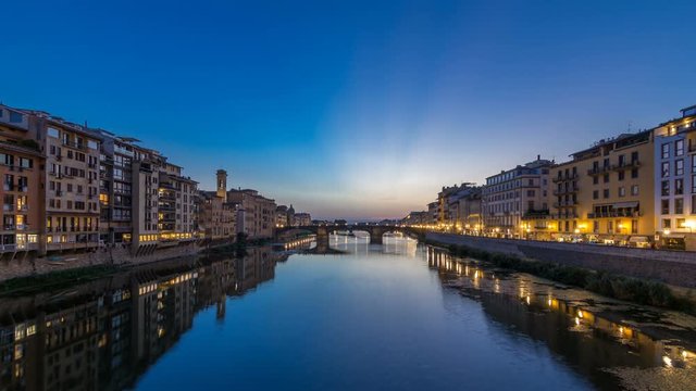 Twilight sky scene of Ponte Santa Trinita Holy Trinity Bridge day to night timelapse over River Arno