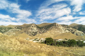 Горный пейзаж, Дагестан, множество вершин, осень, небо, облака.