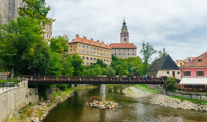 Fototapeta na wymiar Krumlov Castle and pedestrian bridge across the Vltava in Cesky Krumlov in the Czech Republic in September