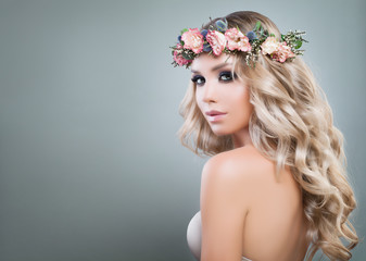 Beautiful Lady Fashion Model with Roses Flowers and Green Leaves in her Hair