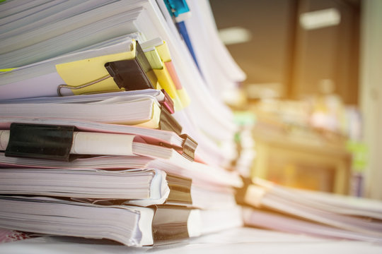 Paper Stack, Pile Of Unfinished Documents On Office Desk Related To Business Functions. Stack Of Business Papers For Annual Report Files, Document Is Written,drawn,presented. Business Offices Concept.