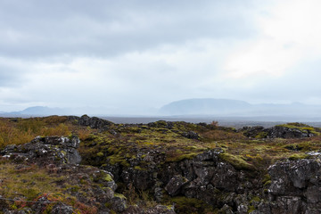 Fototapeta na wymiar Murky mountains over the green mossy rocks