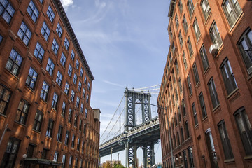 Fototapeta na wymiar Brick wall buildings and Manhattan Bridge in Brooklyn New York City, United States