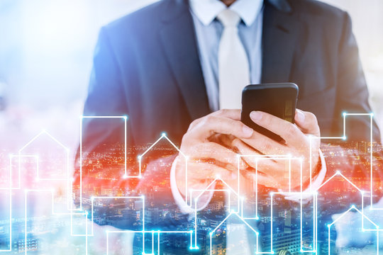 closed up business man using smartphone for connecting prople in business success concept with light liner in city building shape night time.