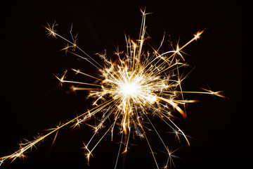 Fototapeta premium Light sparkles Bengal lights on a black background isolated