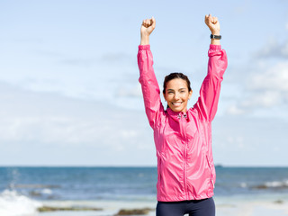 Athletic woman in sportswear standing at the seaside