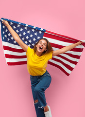 Cheerful woman with flag on pink