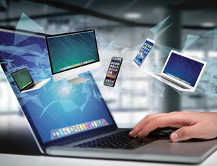 Computer and devices displayed on a futuristic interface - Multimedia and technology concept