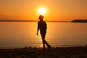 Man at lake in sunset