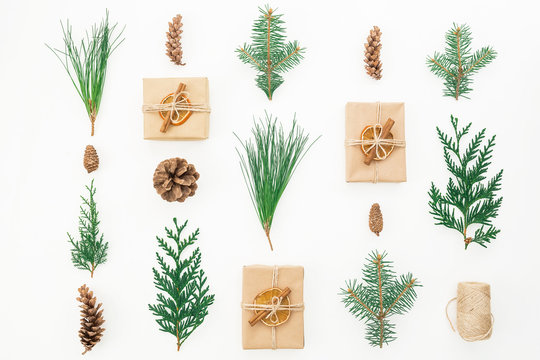 Christmas concept. Gift box, winter plants and cones on white background. Winter, new year composition. Flat lay. Top view