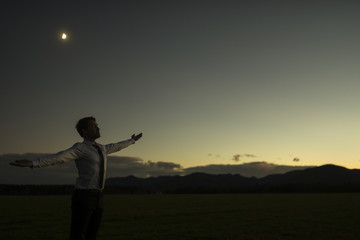 Fototapeta premium Businessman celebrating a new dawn outdoors