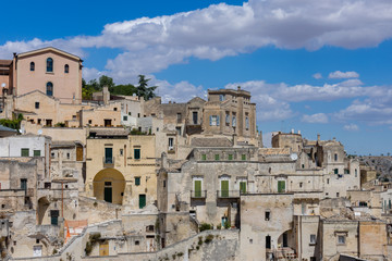 Fototapeta na wymiar Panoramic view of the ancient town of Matera (Sassi di Matera), European Capital of Culture 2019, under blue sky, Basilicata, southern Italy