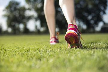 Runner feet running on road closeup on shoe