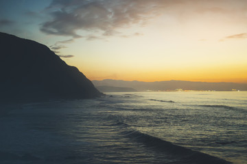 Clouds blue sky and gold sunlight sunset on horizon ocean, background seascape dramatic atmosphere rays sunrise. Relax view waves sea with ship, mockup nature evening concept, copy space for text.