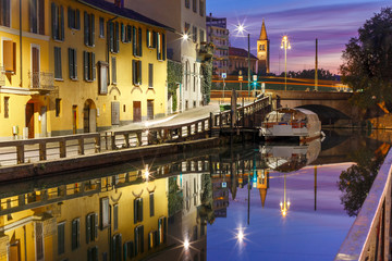 Fototapeta na wymiar Bridge across the Naviglio Grande canal at sunrise, Milan, Lombardia, Italy