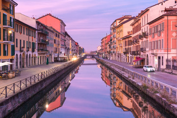 Fototapeta na wymiar Bridge across the Naviglio Grande canal at sunrise, Milan, Lombardia, Italy