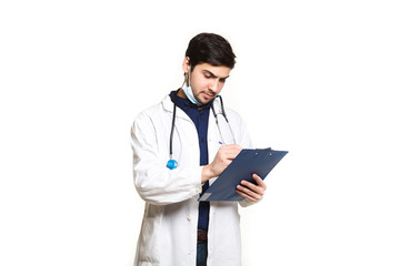 Fototapeta premium beautiful young doctor in a dressing gown with a stethoscope on a white background in the studio,with the ass, records a medical history