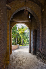 Fototapeta na wymiar Brick arch, secondary entrance of Saludecio, a little medieval town in the Montefeltro, in the Emilia Romagna region, between Rimini and Urbino