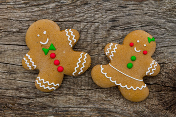 Christmas gingerbread couple cookies on rustic wooden table