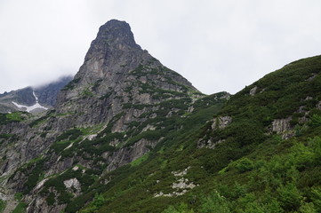 Fototapeta premium Nature in High Tatras in Slovakia. Mountains of rocky rocks cliffs and waterfalls suitable as background pictures of wishes, banners.