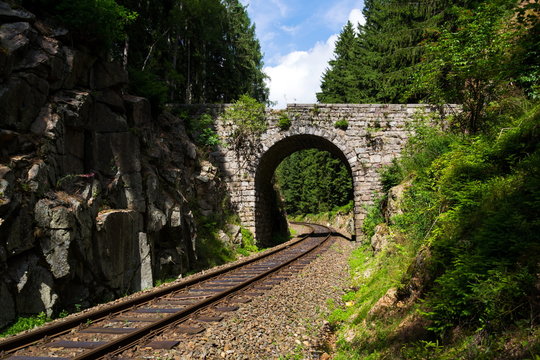 Romantic stone bridge over railway in beautiful forest, Czech republic