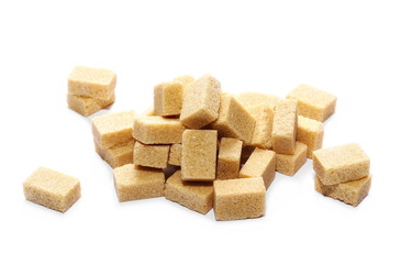 Brown cane sugar cubes isolated on white background