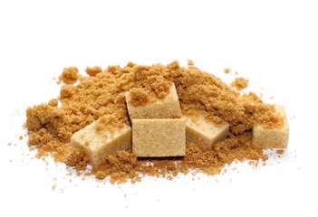 pile unrefined light brown cane sugar cubes on white background