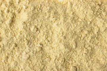 Fenugreek powder spice as a background, natural seasoning texture