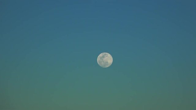 Full moon at an evening sky.