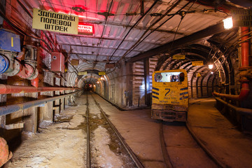 Underground emerald ore mine shaft tunnel gallery passage with light
