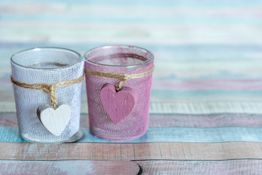 Decorative rose and white candle cups with wooden heart ornament 