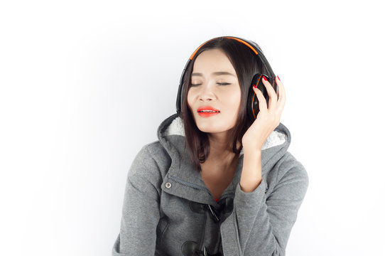 Beautiful asian girl from Thailand sing song from Headphones on white background