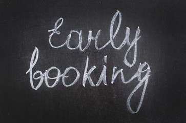 Text Early Booking handwritten with white chalk on a blackboard. banner for sale offer.