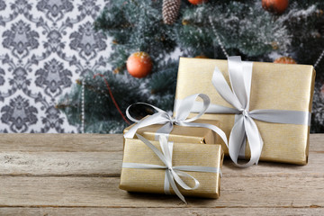 Christmas presents on decorated tree background, holiday concept