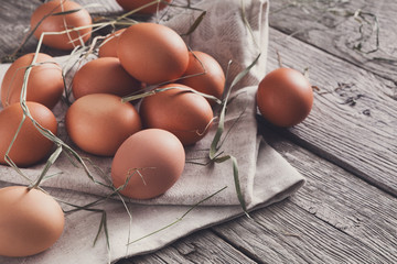 Fresh chicken brown eggs on rustic wood, organic farming concept