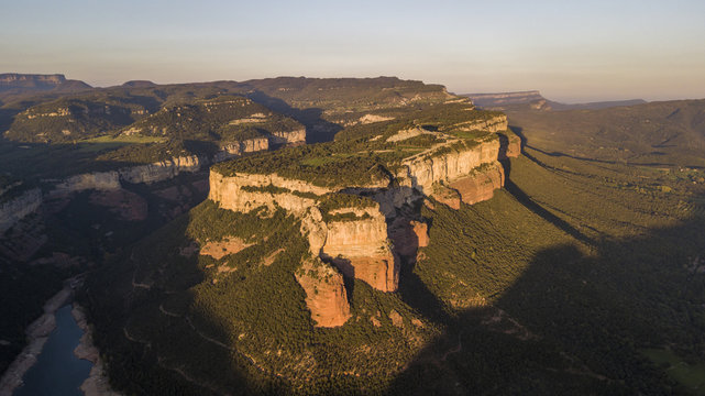 Aerial view of colorful sheer cliffs above Sau reservoir near Tavertet in Catalonia, Spain