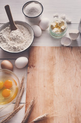Baking ingredients on rustic wood background