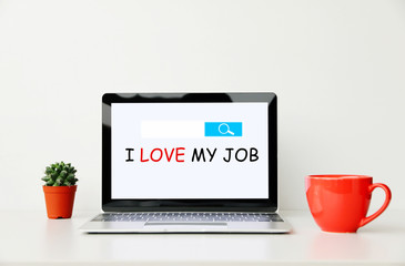 I LOVE MY JOB text on screen Laptop on work desk