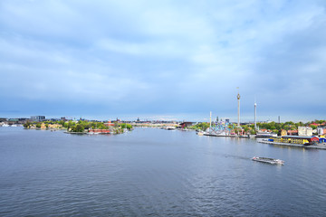 Fototapeta premium 2014 May 15, water craft against sea port and city line, Stockholm, Sweden.