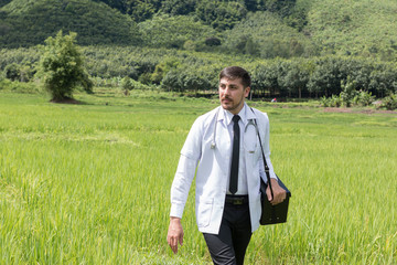 Docter Pointing Height Destination to Future in the Green Wheat field Searching for the New Startup...