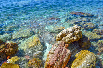The sea view. Beautiful view from the mountain to the calm Adriatic sea. Blue clear water and large stones.