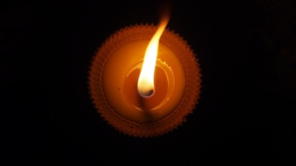 burning flat candle at night isolated on dark background