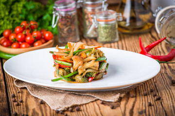 olive oil pouring into bowl of salad