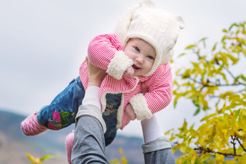 loving mother and her baby child playing outdoors