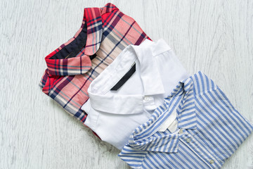 Three shirts, white, checkered, striped. Fashionable concept.